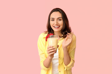 Young woman with tasty yogurt on color background