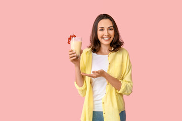 Young woman with tasty yogurt on color background