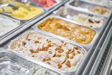Fruit with raisins Gelato. Flavors various ice cream in Rome, Italy. Italian gelateria. Assortment of colorful gelato on cafe showcase. Natural fresh ice cream.