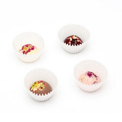 Handmade chocolate candies with a variety of dried fruit and nut toppings