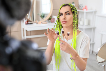 Transgender beauty blogger recording video at home