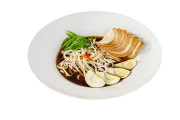 fo bo soup, with vegetables, noodles, greens onions, egg, chicken, spicy red sauce in a white plate isolated white. Serving dishes in a cafe, restaurant, for a menu, Side view