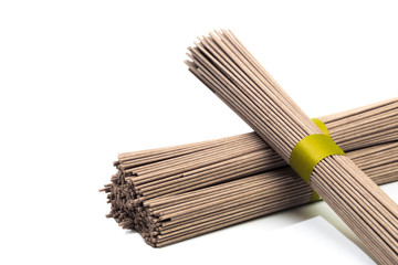 Dried raw japanese soba noodle sticks isolated on a white background. - Image