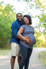 Portrait of a happy pregnant African American couple.