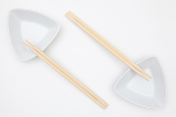 Fototapeta na wymiar Top View Of White Empty Sushi Plates With Bamboo Chopsticks.