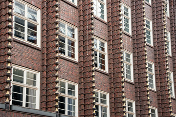 Brown brick facade of a palace with windows