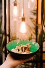 Small pancakes in a plate with berries and homemade sour cream, desserts in a cafe, children's menu, selective focus