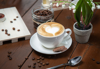 cup of coffee and cake on wooden table