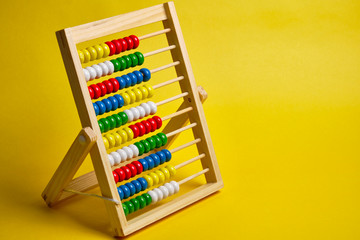 Abacus at yellow background. Shopping, personal finances, money spendings concept