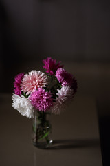 bouquet of flowers in vase on black background