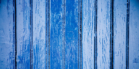 Fototapeta na wymiar Old weathered wooden plank painted in blue wood sea color