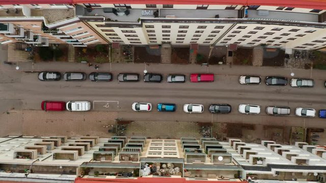 Drone flies sideways over side road, Stockholm. Aerial view of car on street, Europe.