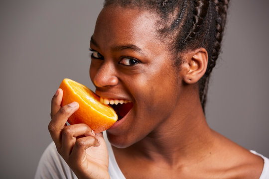 Young Woman Of African Traits Posing With Fruits And Vegetables