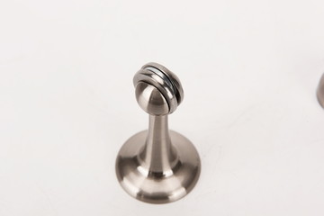 Various metal door stop tools on white background