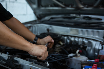 Men are using hands to change the car engine oil to extend the service life.