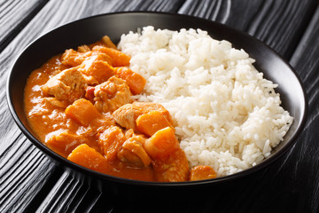 African stew Domoda with peanuts cooked with chicken pumpkin and served with rice close-up in a...