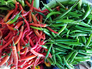 Closeup of red and green chillis for sale in the market.  Food ingredient concept.