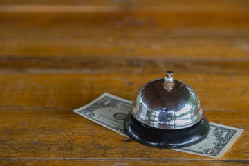 Bell on the table with money