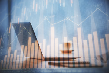 Multi exposure of graph and financial info and work space with computer background. Concept of...