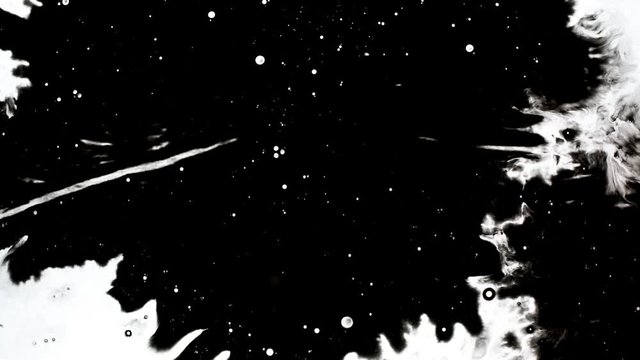 Black ink drops splatters spilling on white background