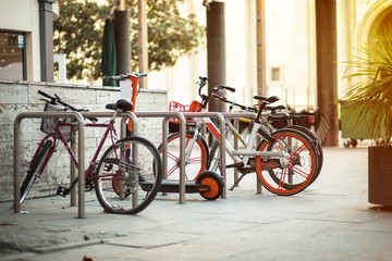 Fototapeta na wymiar ecological and personal transport in town. variety of Bikes and electric scooter