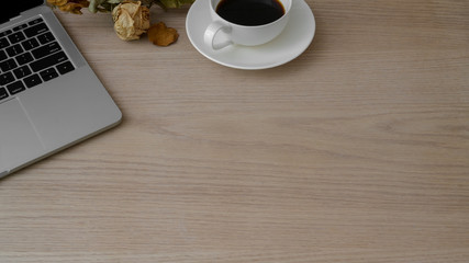 Cropped shot of workspace with laptop, coffee cup and copy space