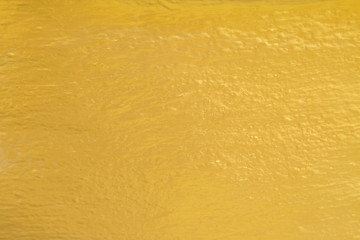 Gold paint on cement wall texture