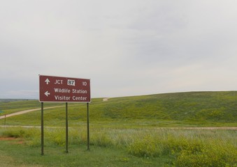 Roadside sign with directions to the Wildlife Station Visitor Center and Junction 87 at Wildlife Loop Road, Custer State Park, South Dakota