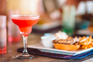 Close up of delicious fresh burger with tasty cocktail