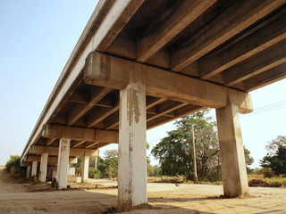 The structure of the bridge and the bridge beams. Create a new road bridge across the ground on a background of blue sky and white. Selective focus