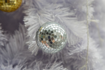 Golden Ball on White Christmas Tree