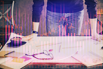 Multi exposure of man standing and planing investment with stock market forex chart.