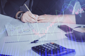 Double exposure of man doing analysis of stock market with forex graph.