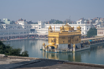 Sikh Golden Temple (sri harmandir sahib), with crowds of people paying respects and praying