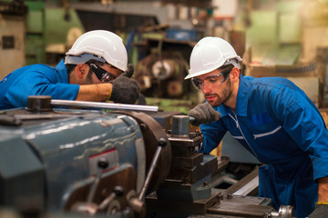 Technicians and engineers are working on machines in a factory. Twins Caucasian man Mechanical...