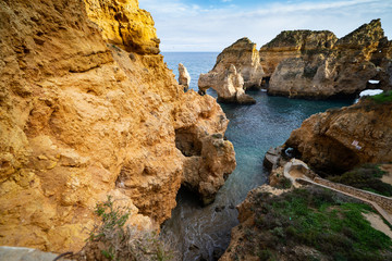 Scenic natural cliff formations and arches of Algarve coastline with turquoise water at Ponta da Piedade, in Algarve Portugal