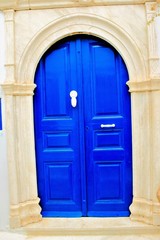 Door with marble decoration, old traditional house in Pyrgos village, Tinos island, Cyclades, Greece.