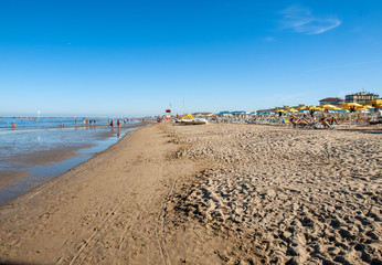 People are resting on a sunny day at the beach in Cesenatico, Italy