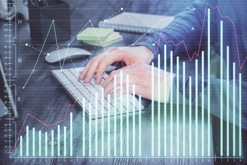 Stock graph with businessman typing on computer in office on background. Concept of analysis....