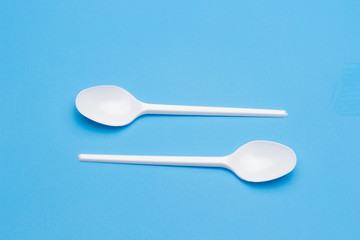 Teaspoon and plastic fork and glass tumbler