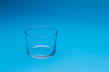 Teaspoon and plastic fork and glass tumbler