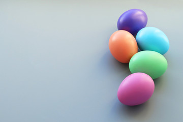 Festive Easter background. Five colorful Easter eggs on a gray background. Selective focus. Copy space