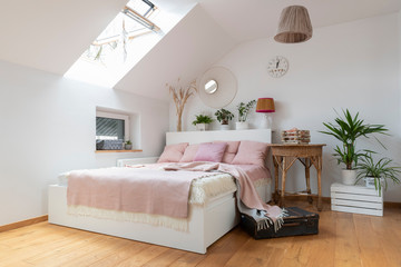 Interior of bedroom in white and pink color in scandinavian style. Spacious and cozy room in the...