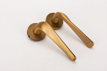 Gold metal handle on white background