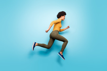 Fototapeta na wymiar Full length body size profile side view of her she nice attractive cheery purposeful wavy-haired girl running fast isolated on bright vivid shine vibrant blue green teal turquoise color background