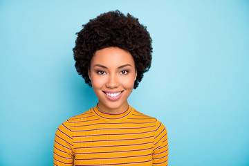 Photo of beautiful pretty dark skin wavy lady toothy beaming smiling positive good mood nice easy-going person wear striped pullover isolated blue color background