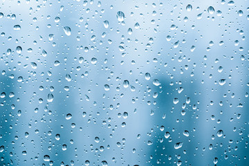 Water​ rain​ drops​ on​ glass​ background.​  Rain​ drops​ on​ a​ Windows. 