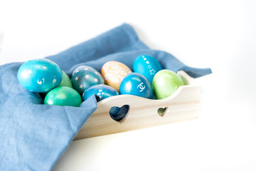 Easter painted eggs in a wooden box, stylish ornament, creative coloring of easter eggs