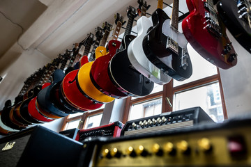 Huge arrenge of professional electric guitars draped in a row in a shop, musical instrument