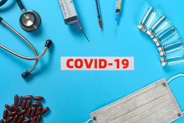 top view covid 19 surrounded by medical things concept of fighting with the SARS COV 2
